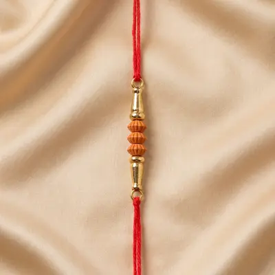 Traditional Red Thread Rakhi with Golden and Orange Beads